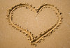 Love is a Beach: A heart drawn in the sand.  Concept of love or simply love of lazing away while on holiday.