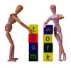 Teamwork: Wooden models demonstrating the skills of teamwork and teambuilding using alphabet blocks.