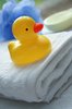 Bath Duck: Yellow plastic duck on a bath towel