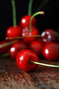 Cherries: Red sweet cherriess on a wooden surface