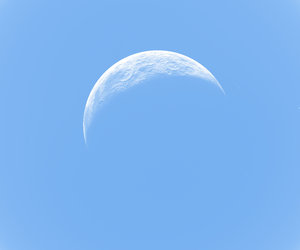 Crescent Moon on Blue: A realistic crescent moon on a light blue background. You may prefer this:  http://www.rgbstock.com/photo/nY4Is7U/Crescent+Moon+and+Star