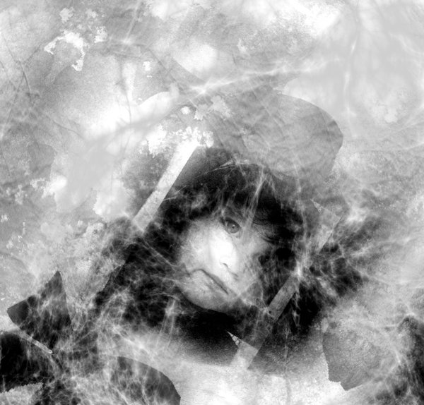 Grunge - Cobwebs on old Photo: Grungy black and white photo of a child's face covered with cobwebs.