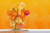 Fruit basket: fruit basket against orange and white background