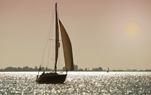 Moonlight sailing: sailboat in twilight