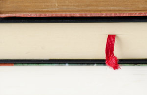 Book mark: red bookmark in a pile of books