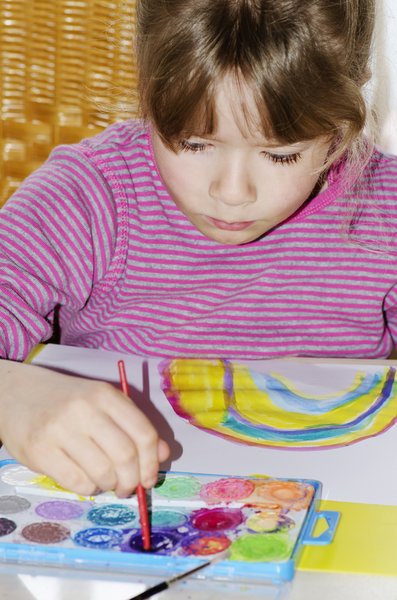 Painter: Child concentrating on her painting